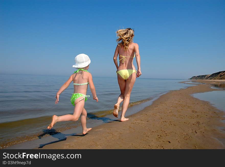 Mother With Child On The Beach