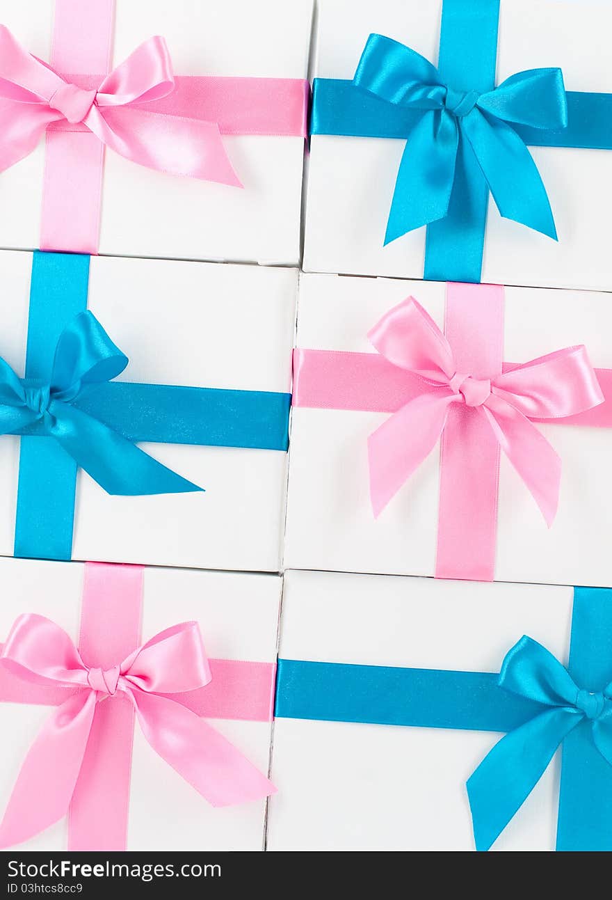 Boxes with pink and blue ribbons on white. Boxes with pink and blue ribbons on white