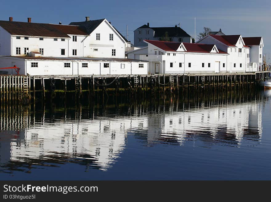 Wooden seaside houses standing on pillars over the water in summer, Lofoten, Norway. Wooden seaside houses standing on pillars over the water in summer, Lofoten, Norway.