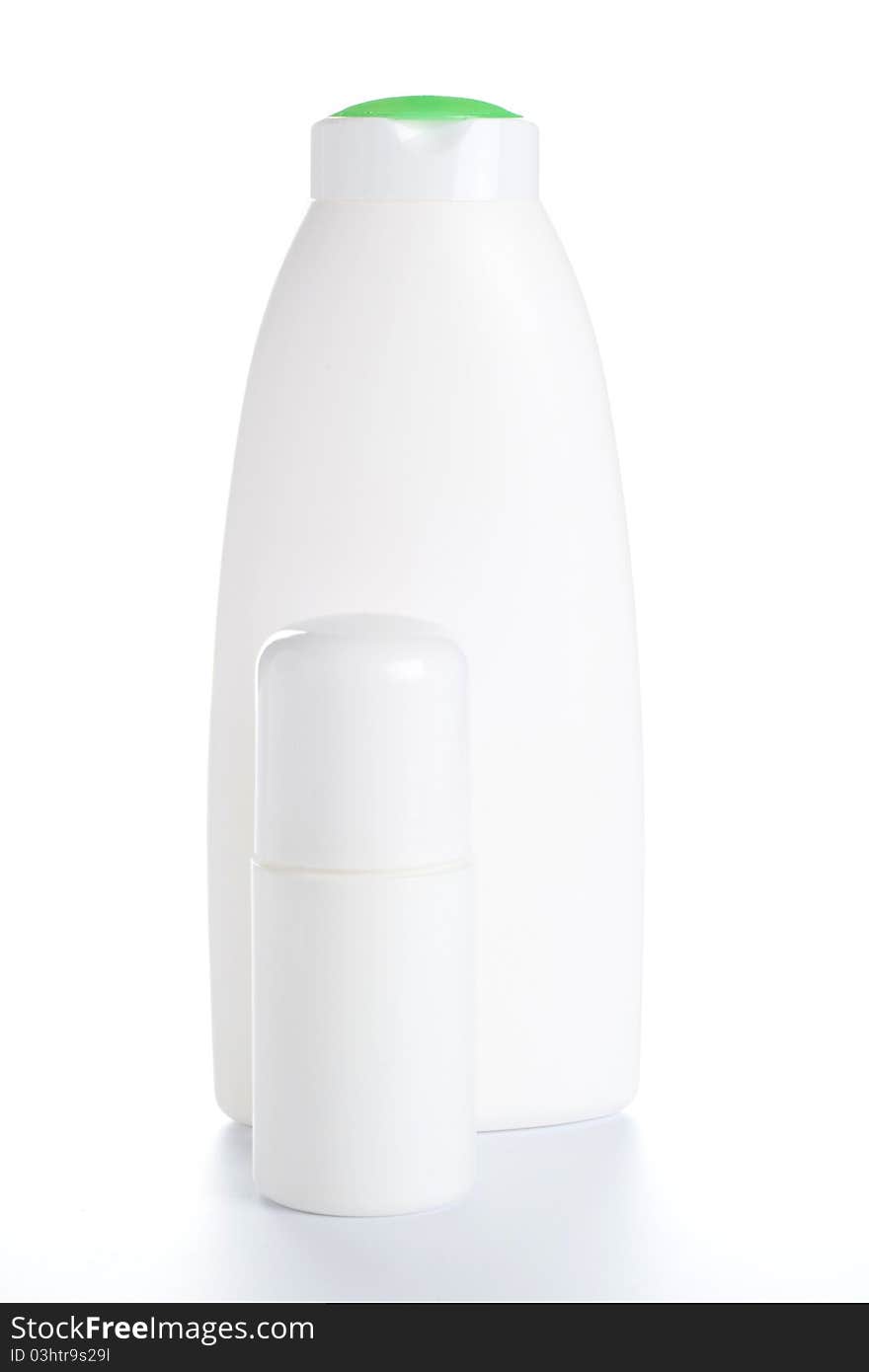 Deodorant and White shampoo bottle with green cap