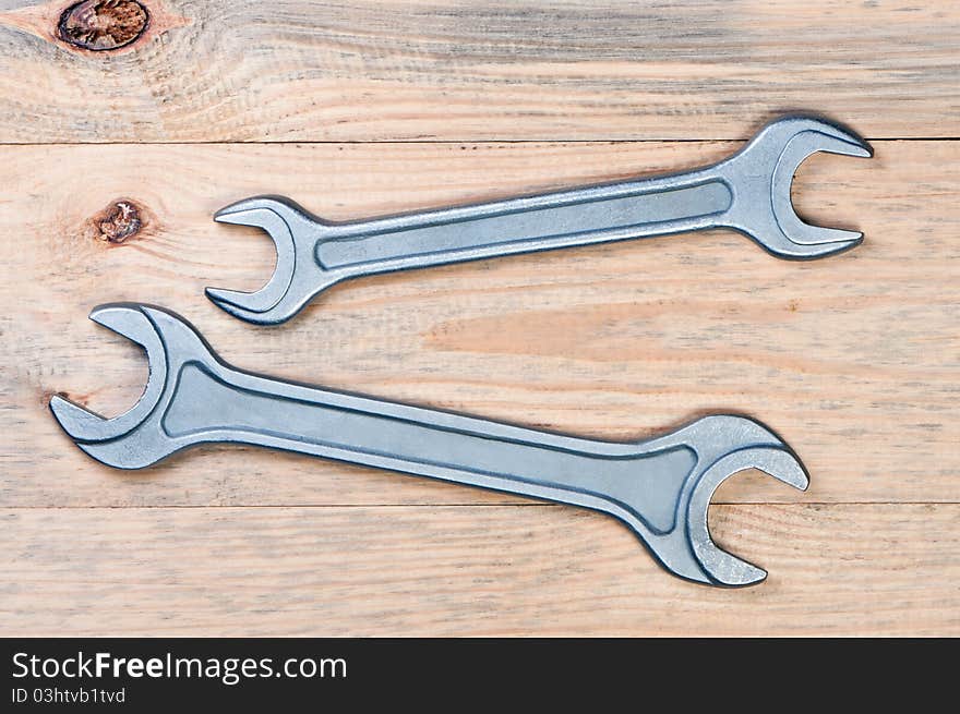 Wrenches on a wooden board. Construction theme.