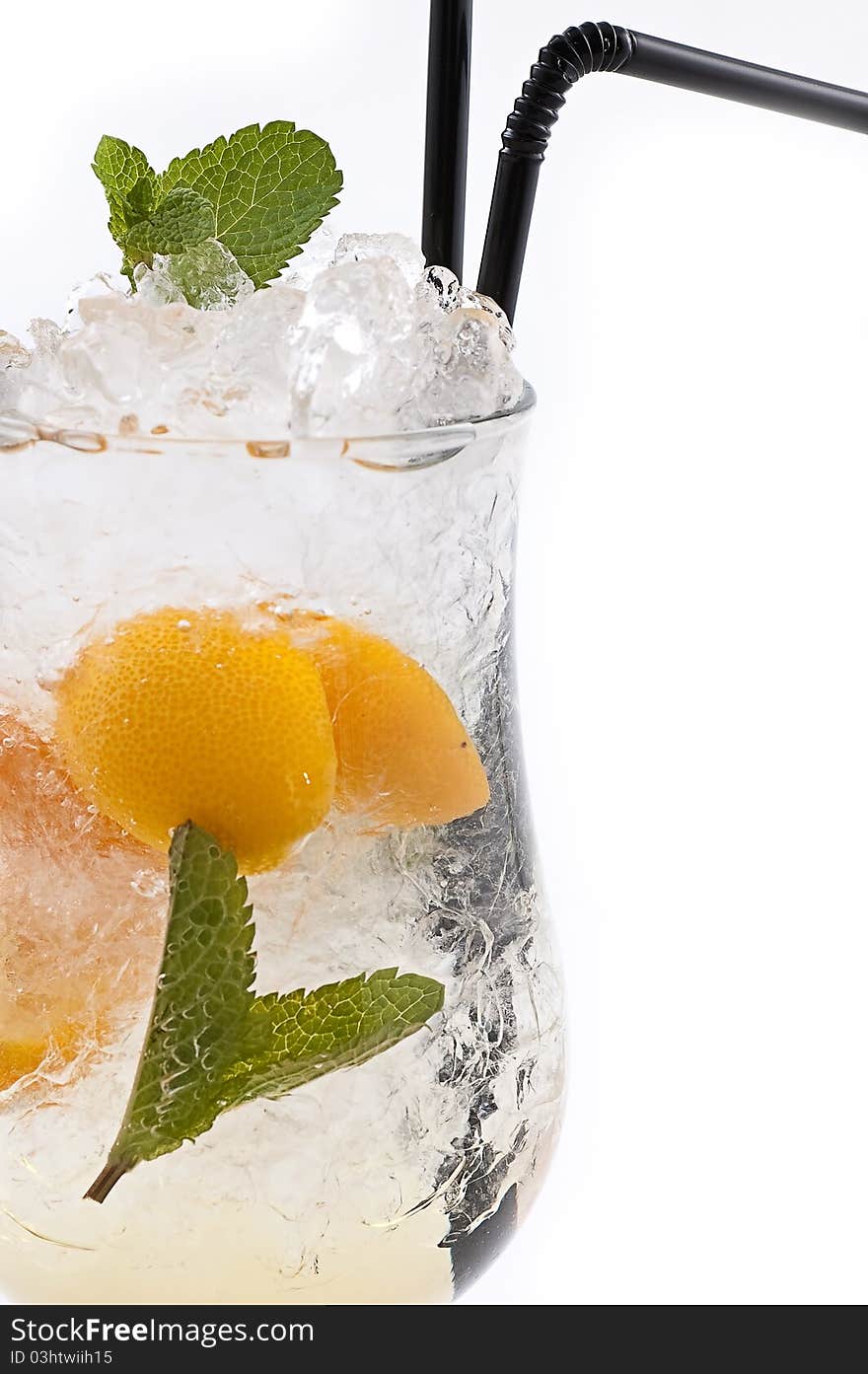 Cocktail with an orange and a lemon with ice slices in a transparent glass close up. Cocktail with an orange and a lemon with ice slices in a transparent glass close up