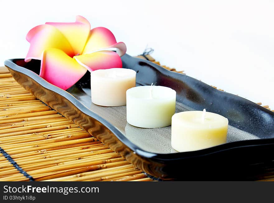 Three Candles And Plumeria In Plate.