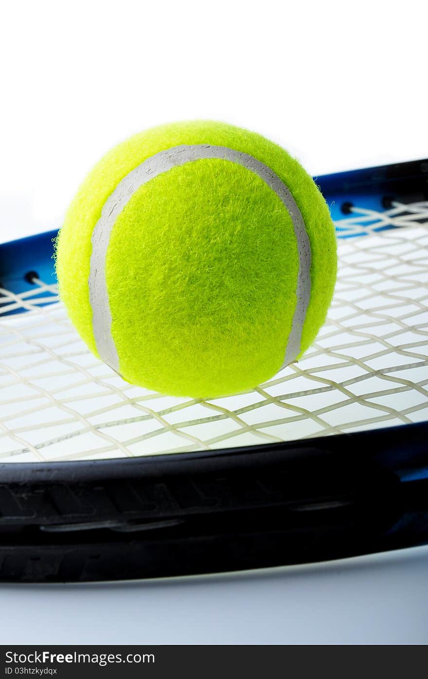 Tennis ball on racket and isolated on white background.