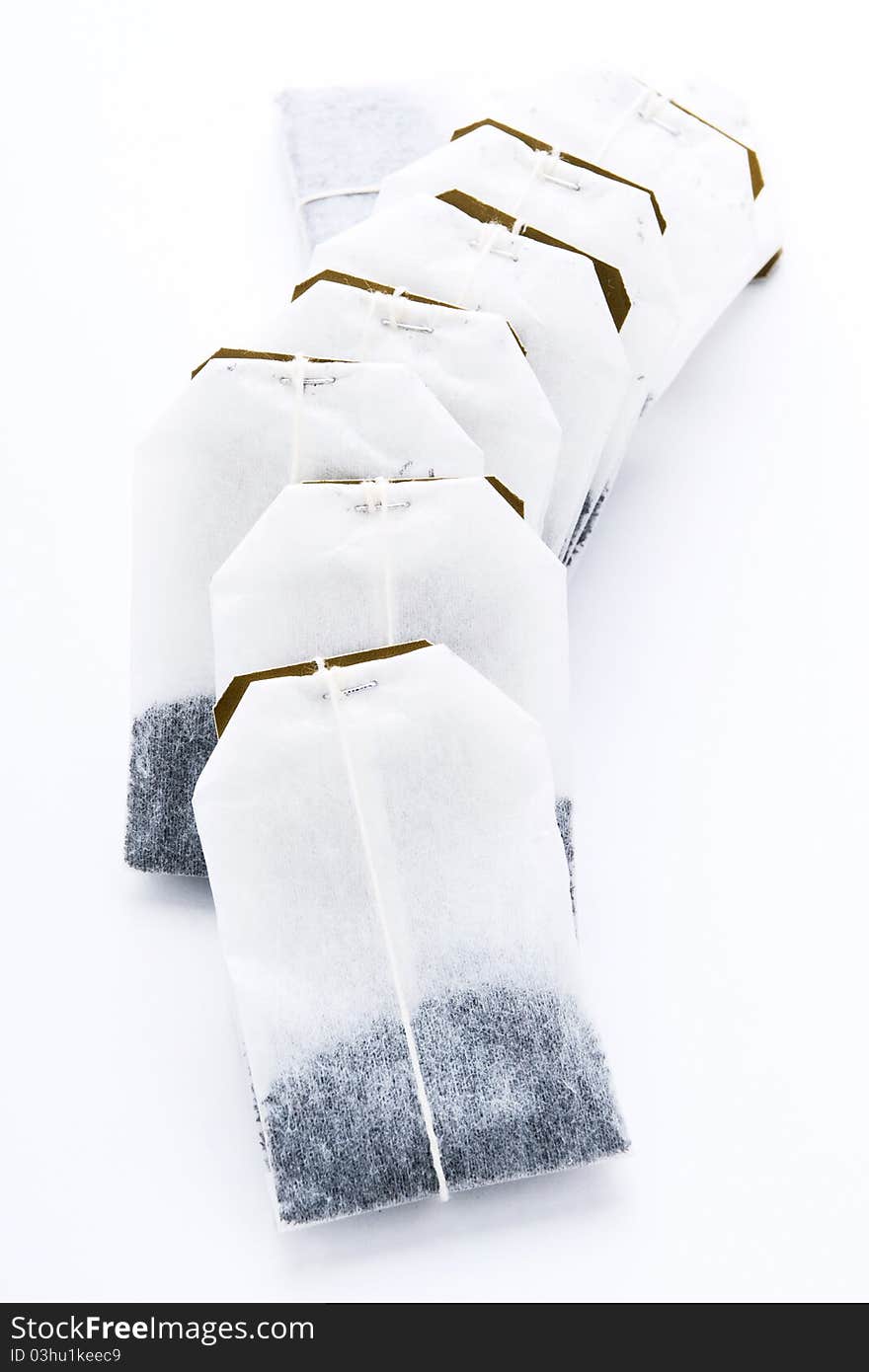 Close-up of tea bags on white