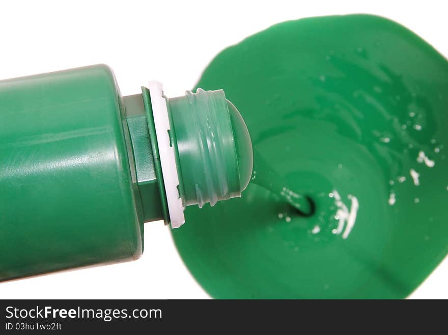 Green paint pouring in bucket