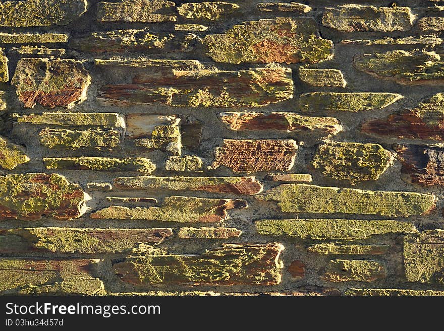 Background texture of sunset lit stone wall