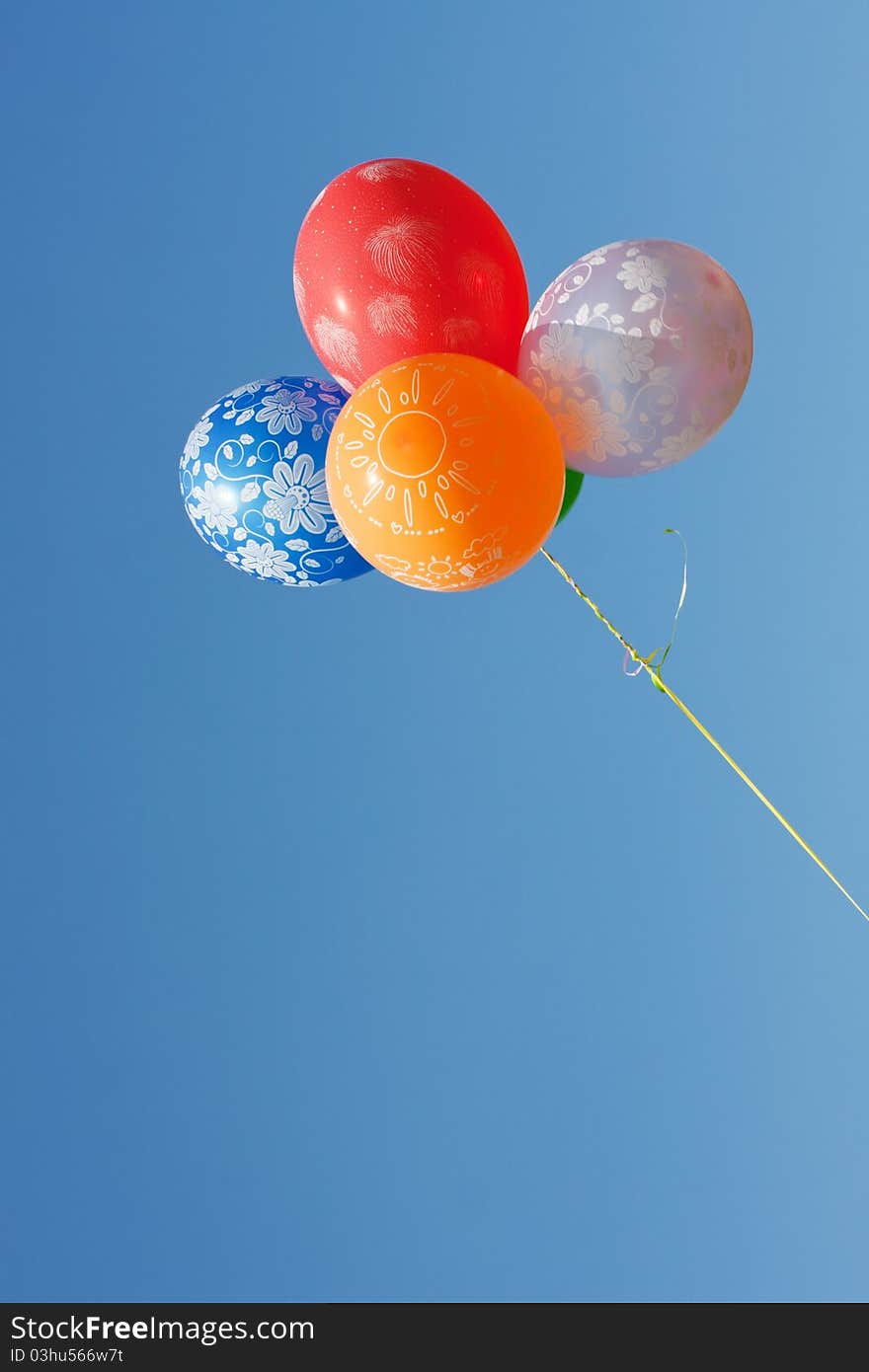 Many beautiful balloons against the blue sky