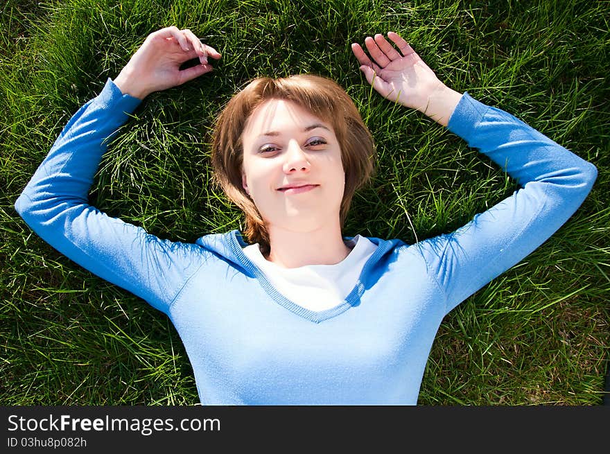 Beautiful girl lying on the green grass. Beautiful girl lying on the green grass