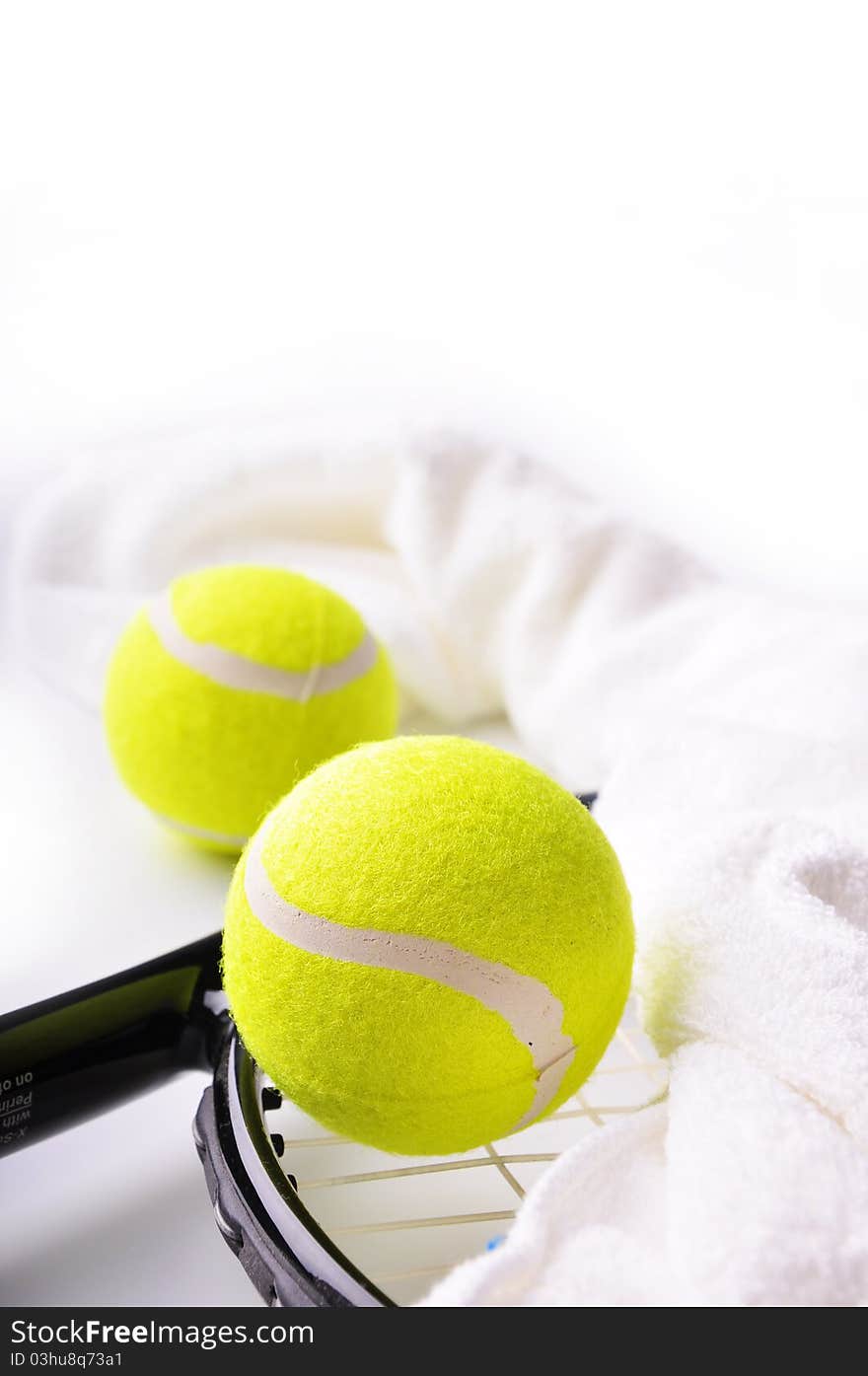 Two tennis balls and white towel on the racket isolated on white background.