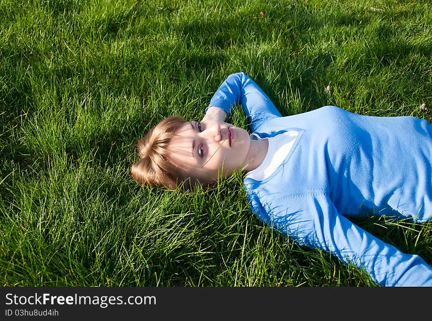 Beautiful girl lying on the green grass. Beautiful girl lying on the green grass