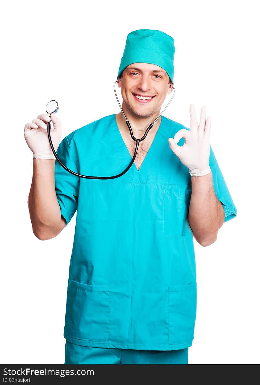 Portrait of a surgeon holding a stethoscope and showing the sigh OK, isolated against white background