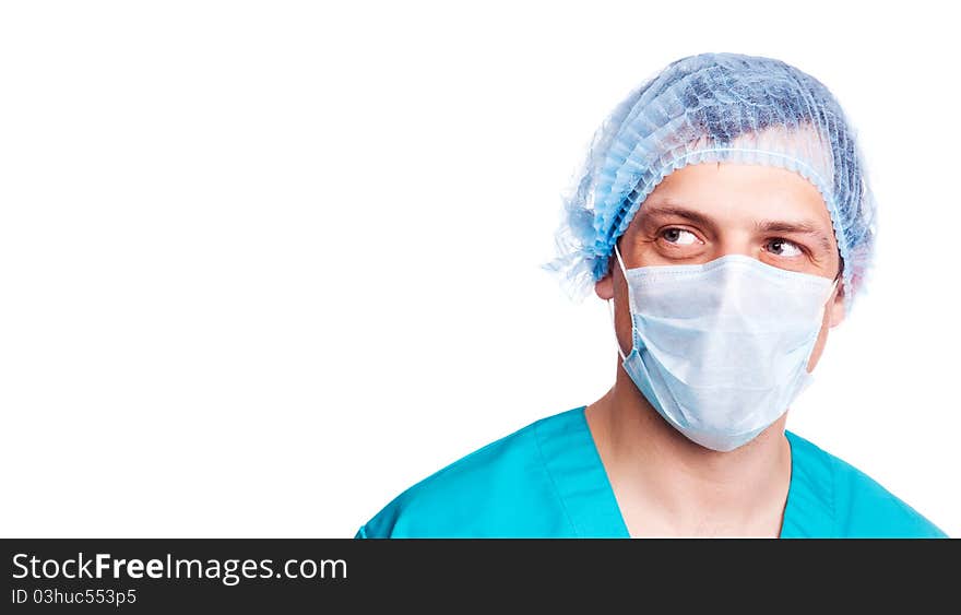 Portrait of a surgeon wearing a mask and green uniform and looking to the right. isolated on white background, copy space for your text to the right. Portrait of a surgeon wearing a mask and green uniform and looking to the right. isolated on white background, copy space for your text to the right