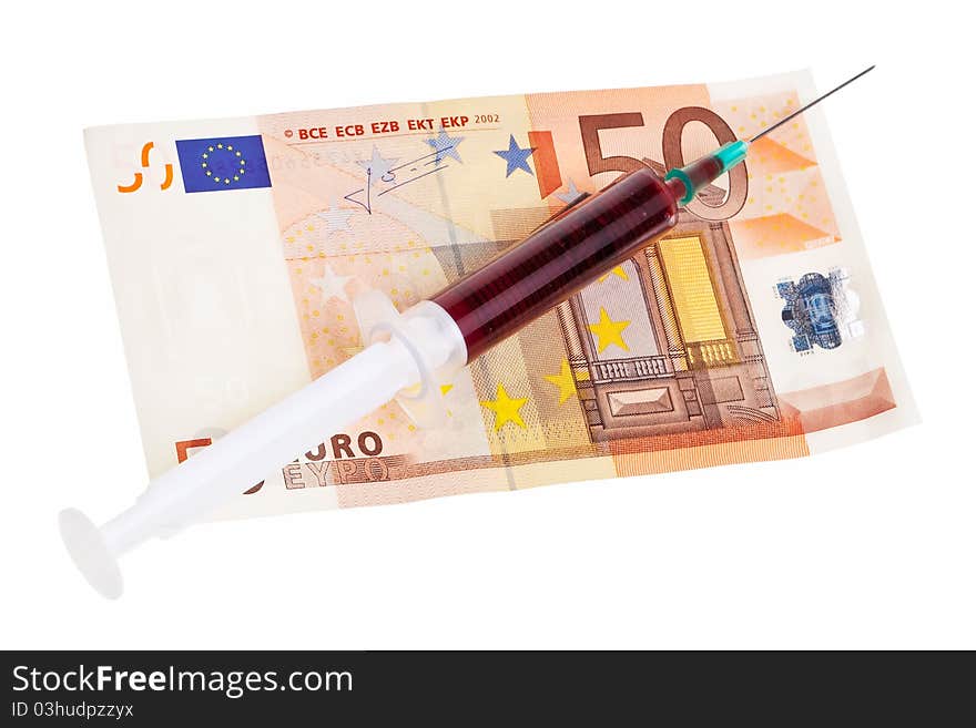 Syringe with red liquid on 50 Euro banknote isolated over white background. Syringe with red liquid on 50 Euro banknote isolated over white background.