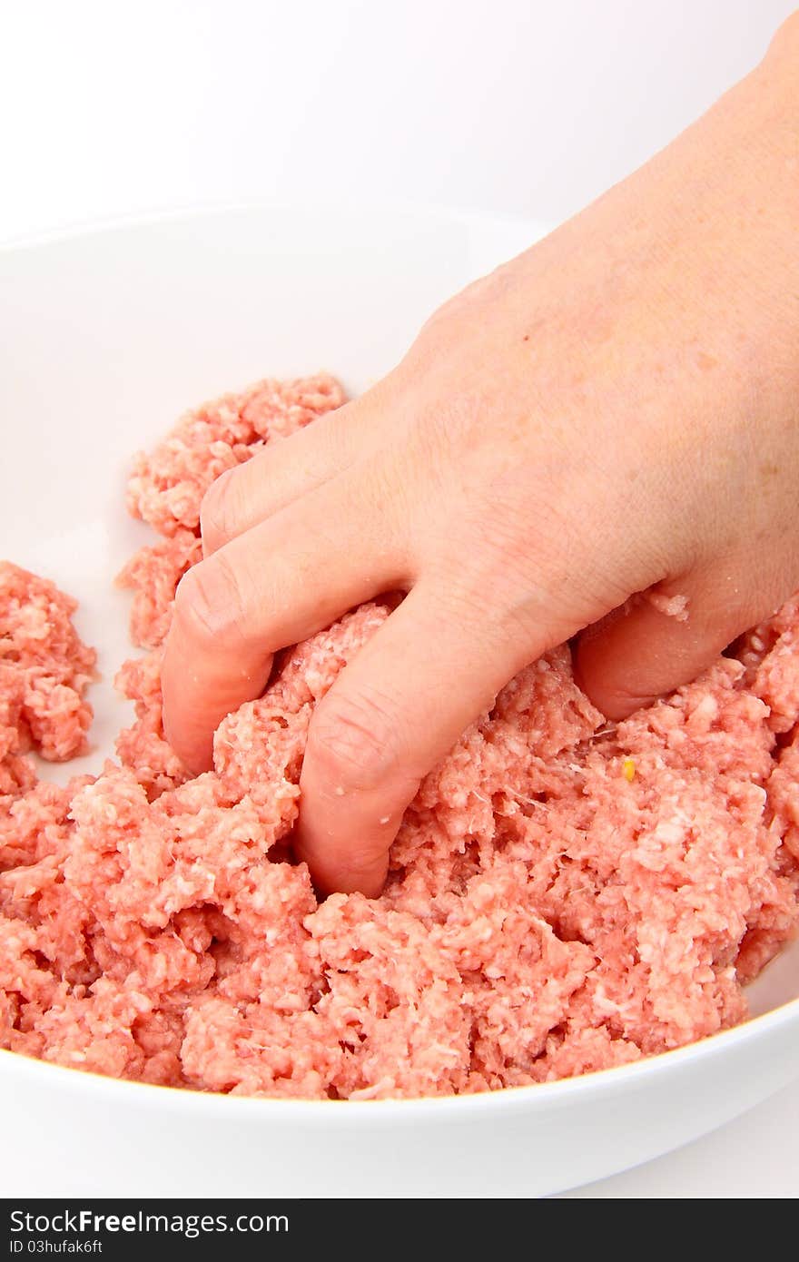 Hand working with minced meat