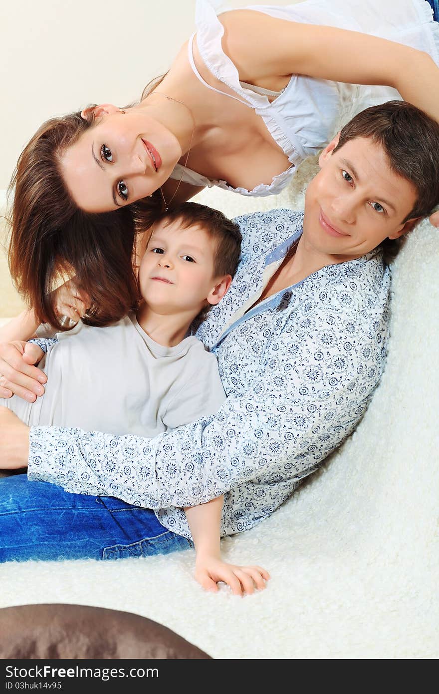 Happy parents with their son at home. Happy parents with their son at home.