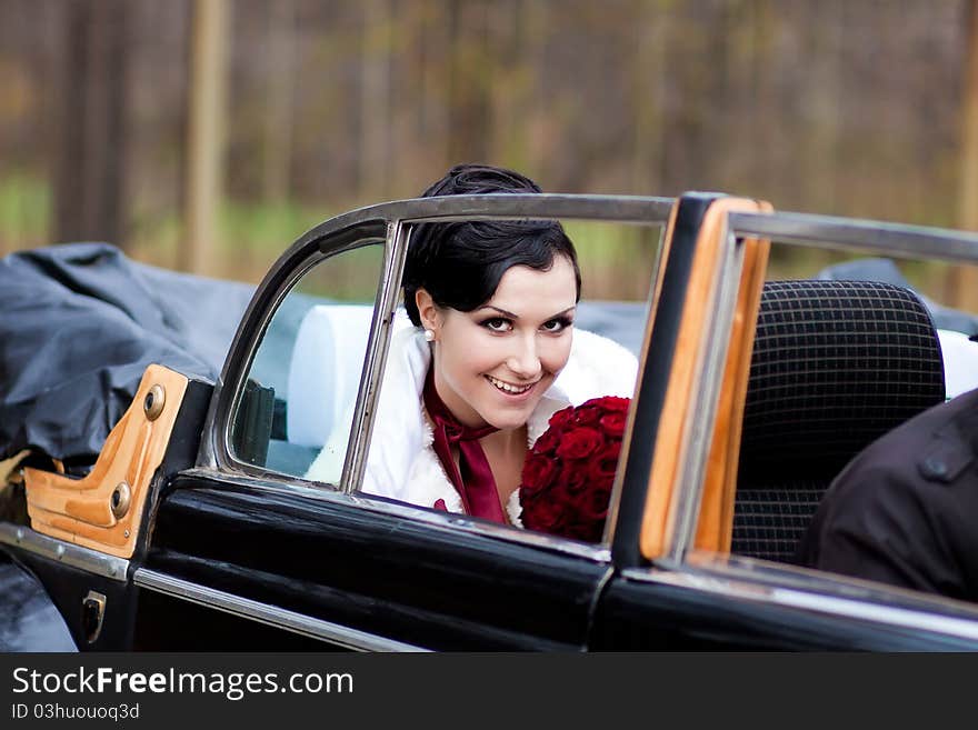 Beautiful bride in black retro car. Beautiful bride in black retro car