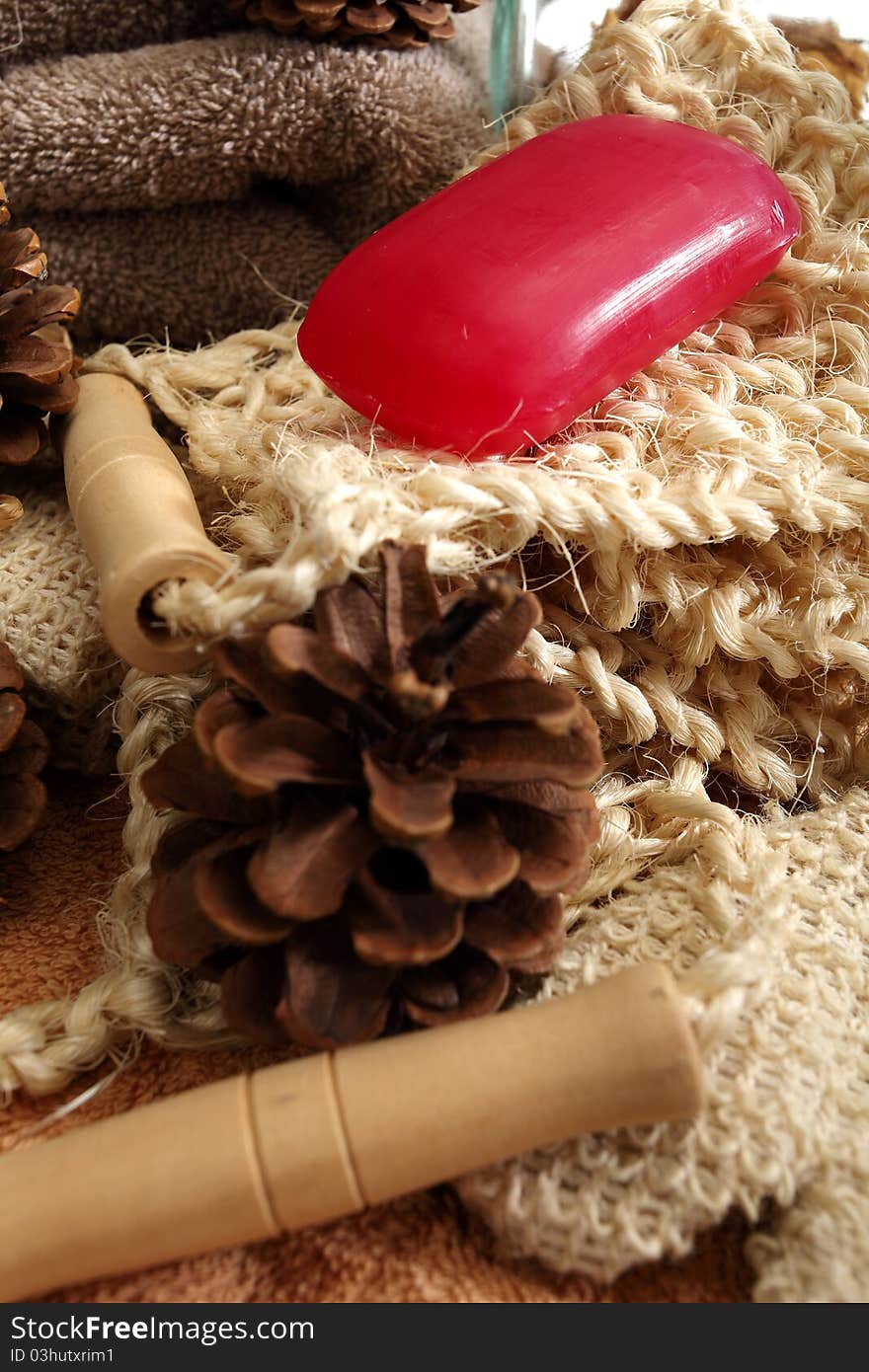 Soap and pine cones placed on a towels and spa accessories. Soap and pine cones placed on a towels and spa accessories