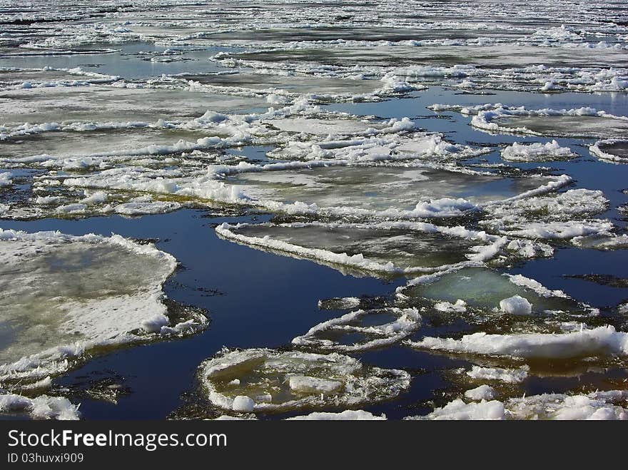 Floating of ice in water in spring background. Floating of ice in water in spring background