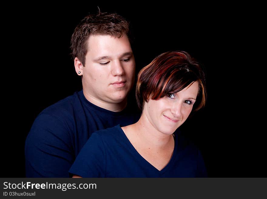 An isolated image of a young man and woman cople.  They are wearing blank t shirts so any text can be entered by the buyer. An isolated image of a young man and woman cople.  They are wearing blank t shirts so any text can be entered by the buyer.