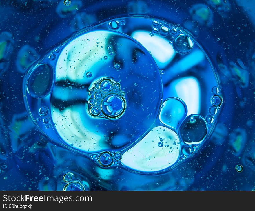 Oil and water separation with blue background. Oil and water separation with blue background