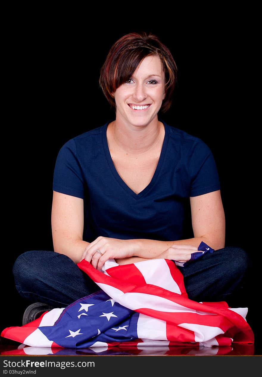 A patriotic image of a woman sitting down with the flag. A patriotic image of a woman sitting down with the flag.