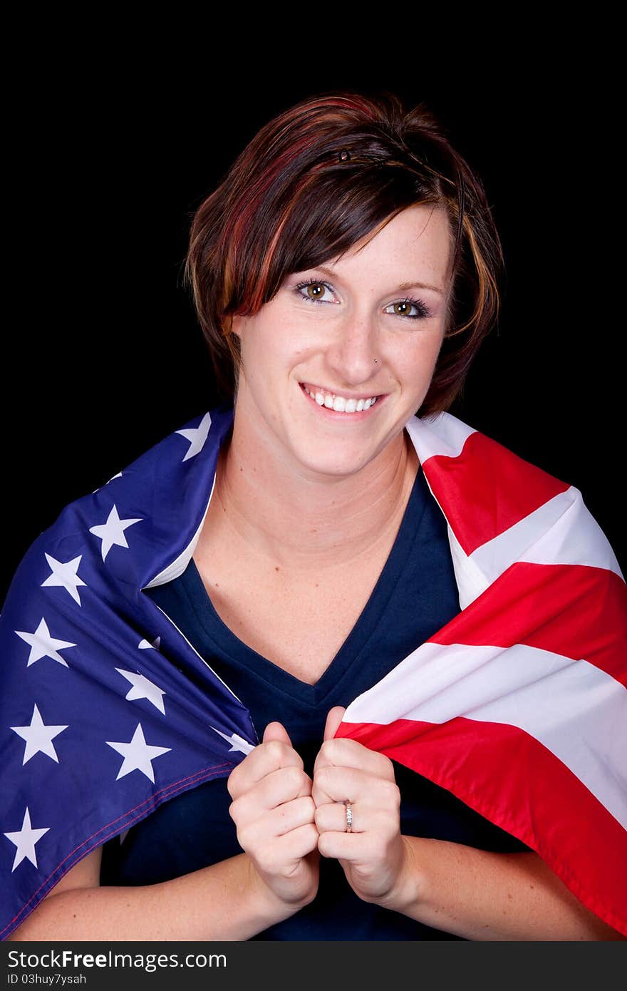 A nice image of a young lady smiling with the American Flag wrapped around her. A nice image of a young lady smiling with the American Flag wrapped around her.