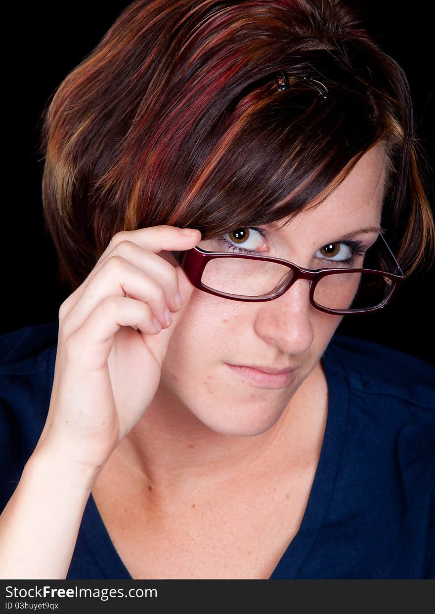 A librarian looks at the viewer with her glasses pulled down. A librarian looks at the viewer with her glasses pulled down.