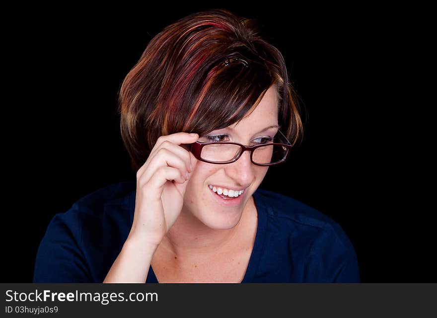 A librarian looks to her left at something that makes her smile. A librarian looks to her left at something that makes her smile.