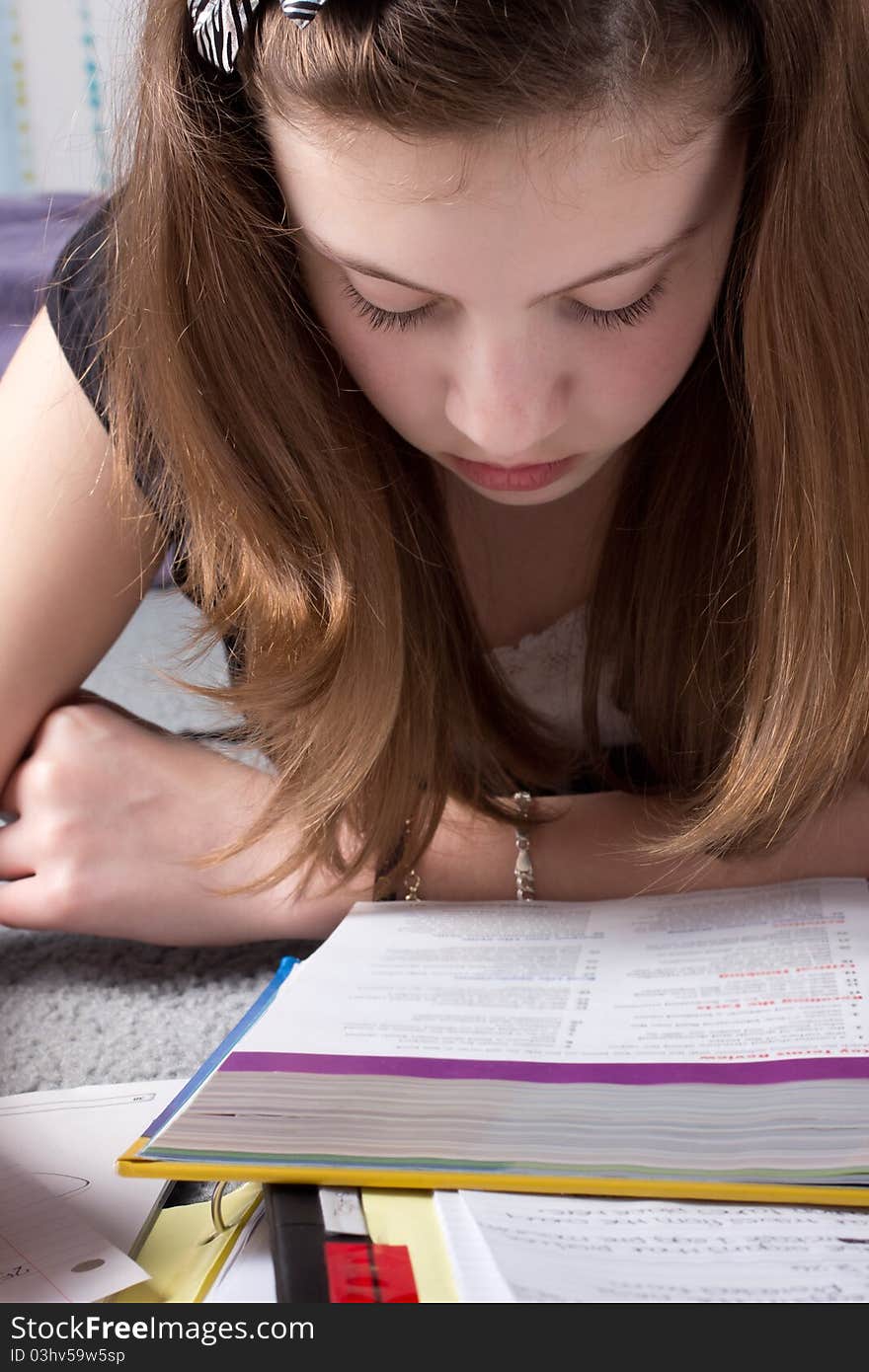 An extreme close-up of a cute girl in deep concentration while studying. An extreme close-up of a cute girl in deep concentration while studying