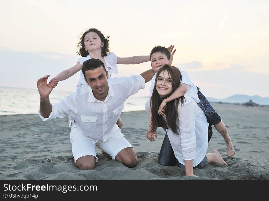 Happy young family have fun on beach run and jump at sunset. Happy young family have fun on beach run and jump at sunset