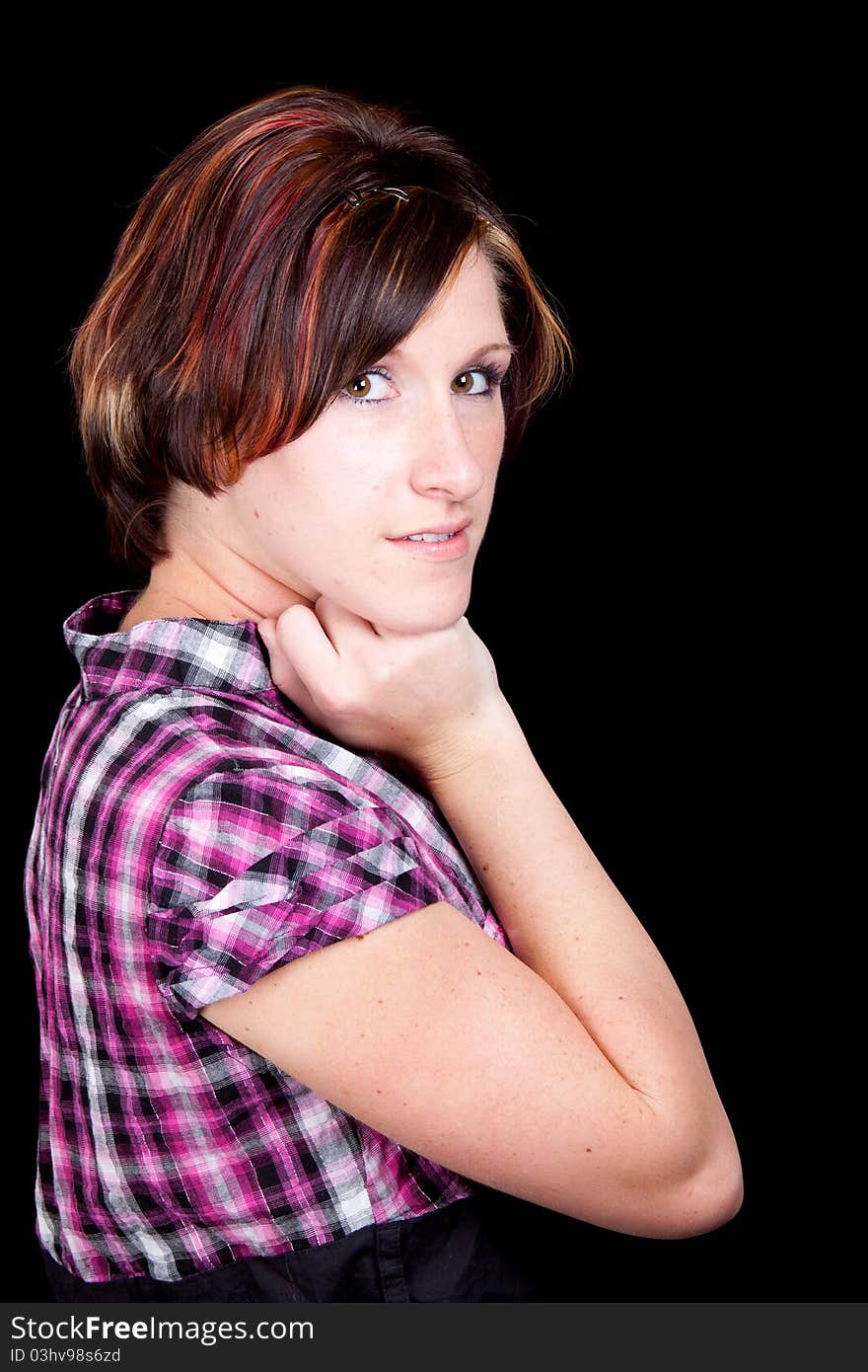 A young lady poses with her arm under her chin. A young lady poses with her arm under her chin.