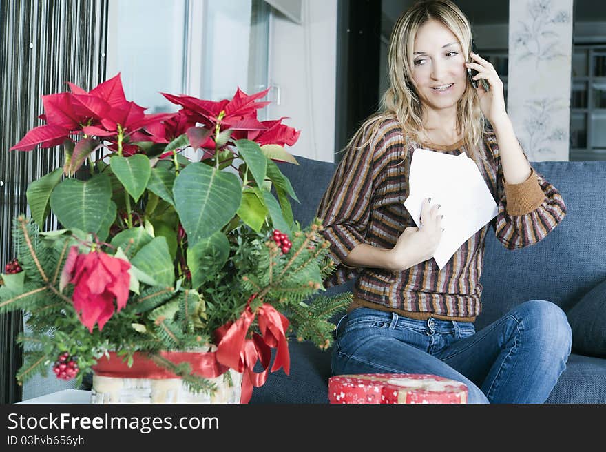 Happy blond woman thanking someone on the phone for a gift. Happy blond woman thanking someone on the phone for a gift