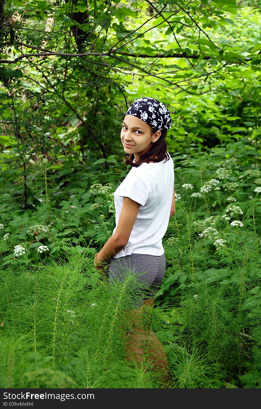 Beautiful smiling teenage caucasian girl in park over natural green background outdoors. Beautiful smiling teenage caucasian girl in park over natural green background outdoors