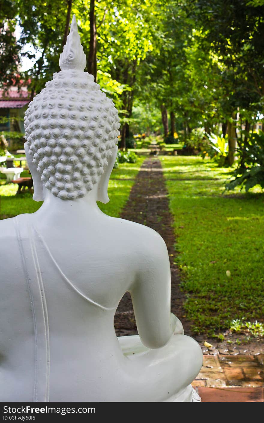 Behind the white Buddha statue on the path. Behind the white Buddha statue on the path.