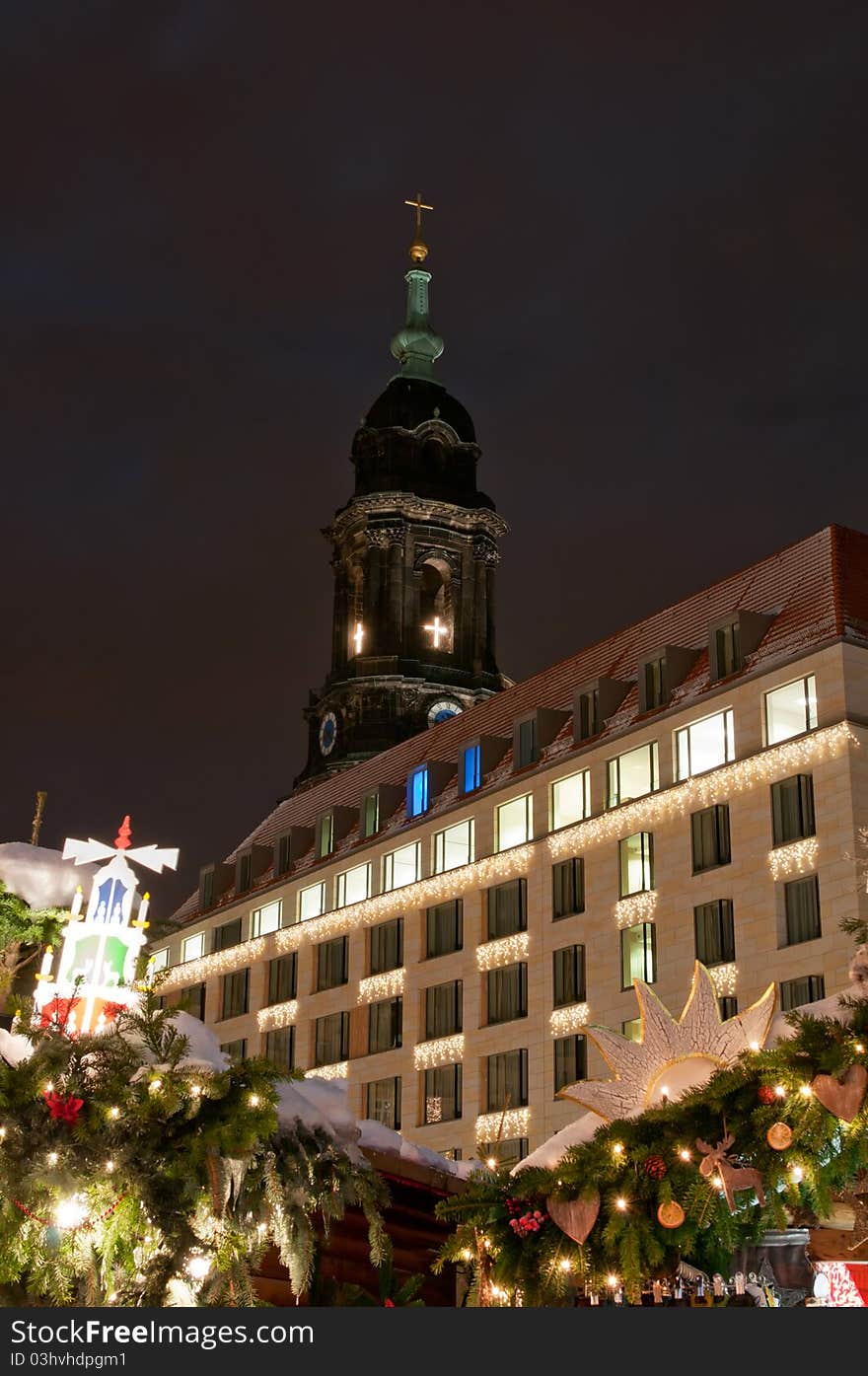 Christmas market in Dresden with tower of Kreuzkirche church.