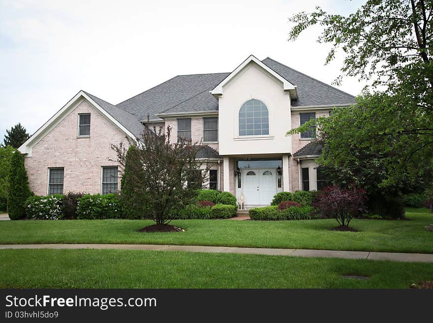 Image of a single family home with many windows and beautiful landscaping. Image of a single family home with many windows and beautiful landscaping.