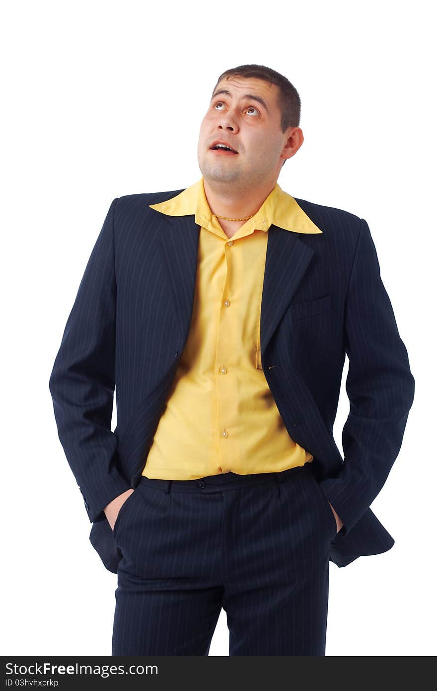 Portrait of a man in yellow shirt and suit looking upward with hands in pocket. Portrait of a man in yellow shirt and suit looking upward with hands in pocket.