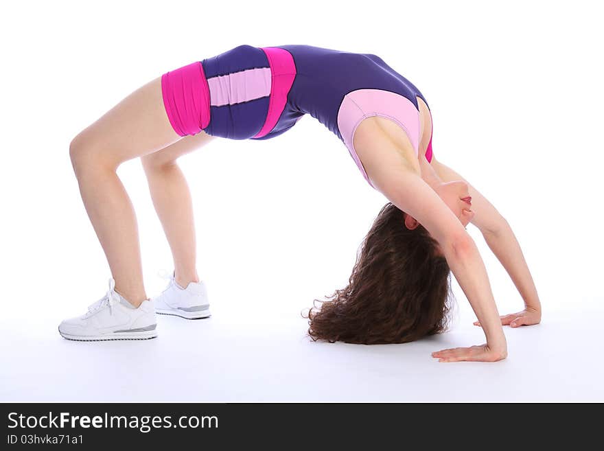 Fit and healthy brunette woman in crab pose during fitness exercise routine. She is wearing bright blue and pink sports clothes and white trainers. Fit and healthy brunette woman in crab pose during fitness exercise routine. She is wearing bright blue and pink sports clothes and white trainers.