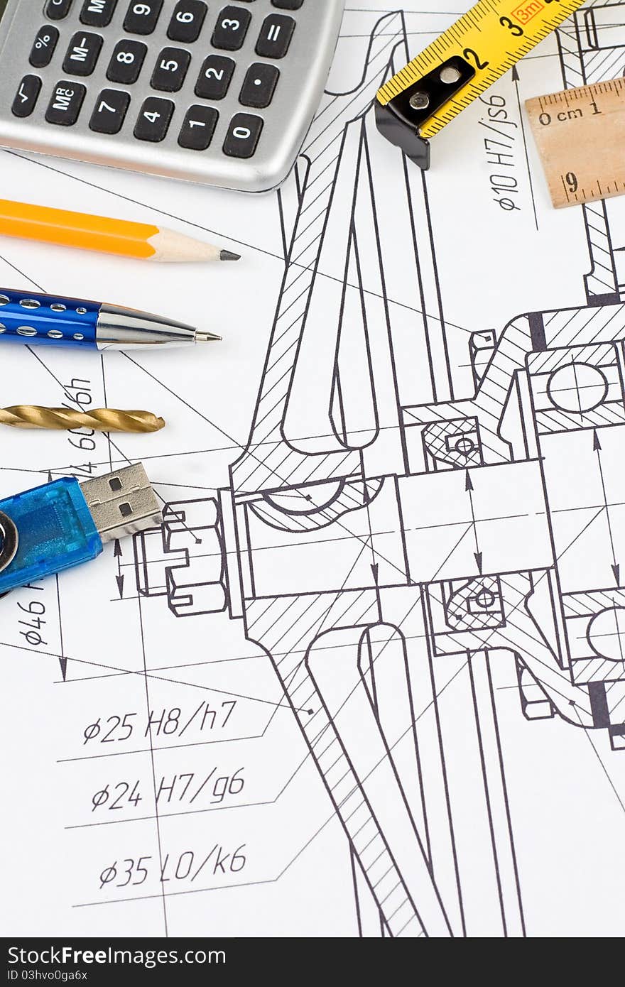 Pen, pencil, flash memory and calculator on engineering drafting