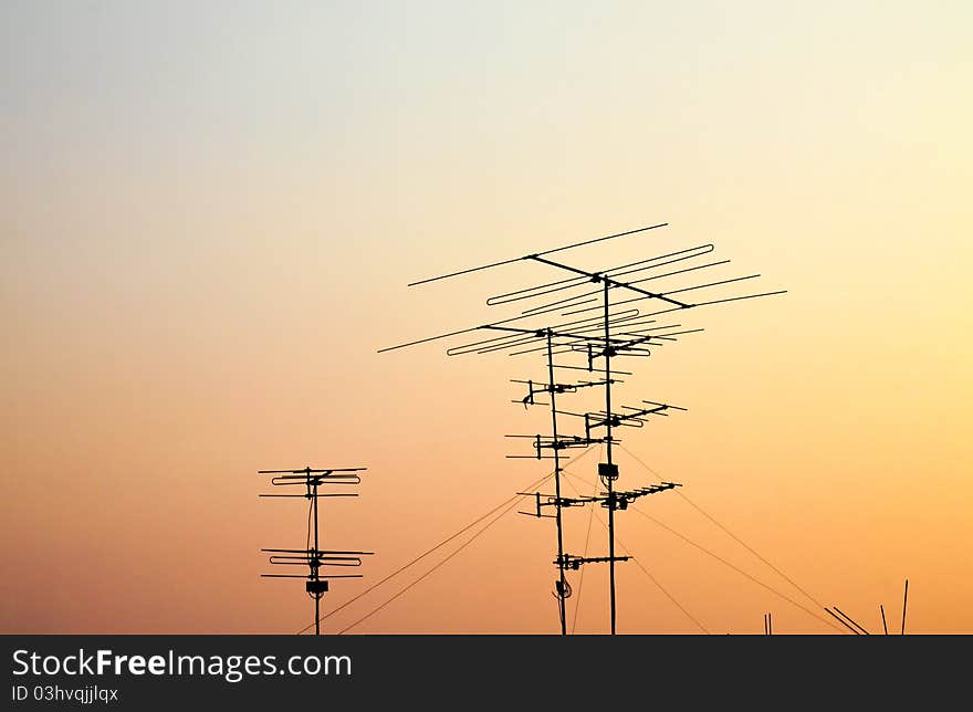 Silhouettes of antennas with sunset