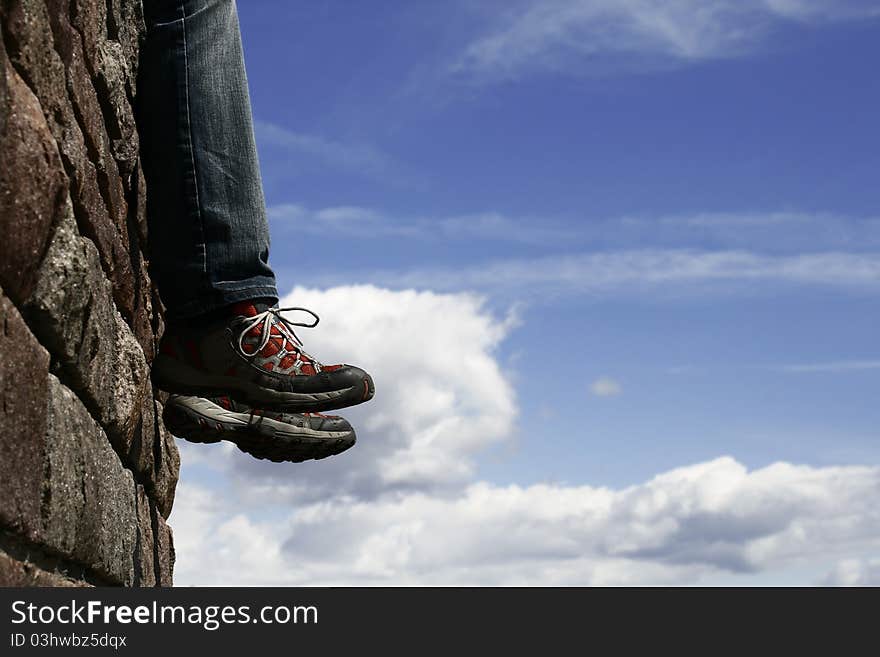 Man sitting on the wall and relaxing. Man sitting on the wall and relaxing