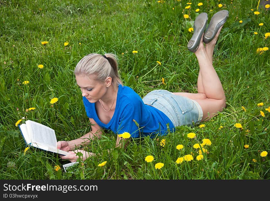 A girl student with a book in the park