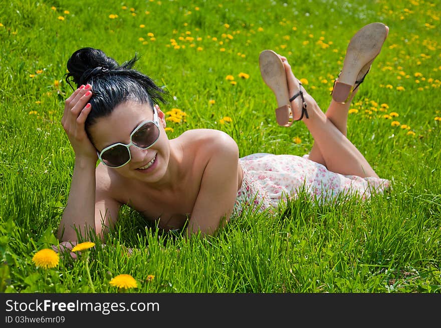 A young girl rests in a park, summer