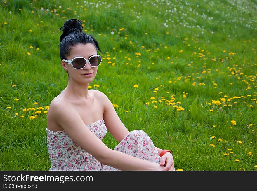 A young beautiful girl rests in a park. A young beautiful girl rests in a park