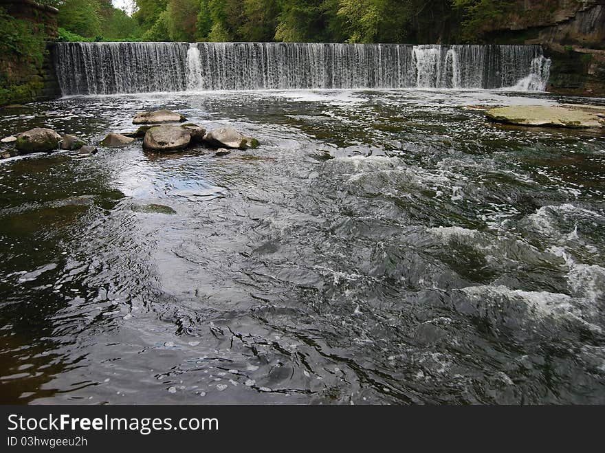 A man made waterfall or weir on the river almond at Crammond