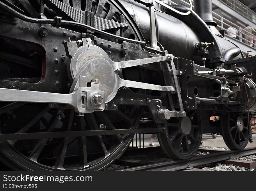 Closeup of vintage steam engine's black, iron wheel. Closeup of vintage steam engine's black, iron wheel