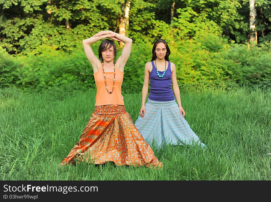 Two girls do yoga