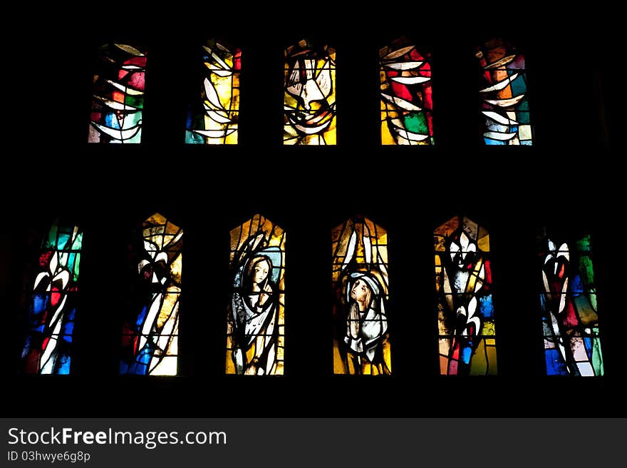 Stained glass windows in the Catholic Church of the Annunciation depict the the Holy Sprit in the form of a dove, the Archangel Gabriel, and Mary.