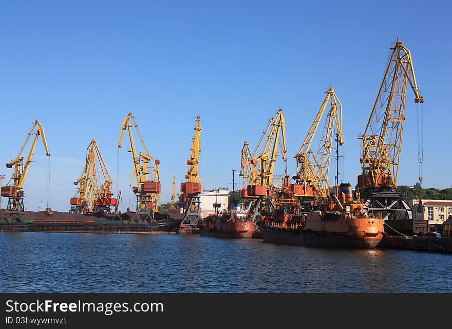 Cranes in a port, unloading ships